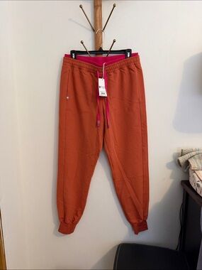 Figs women’s Rust Orange Jogger scrub pants with Hot Pink Waistband